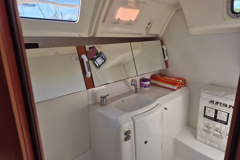 Serene Yacht Photos Pics Beneteau Oceanis 37 bathroom interior, featuring a sink, mirror, and storage, 2011 model.