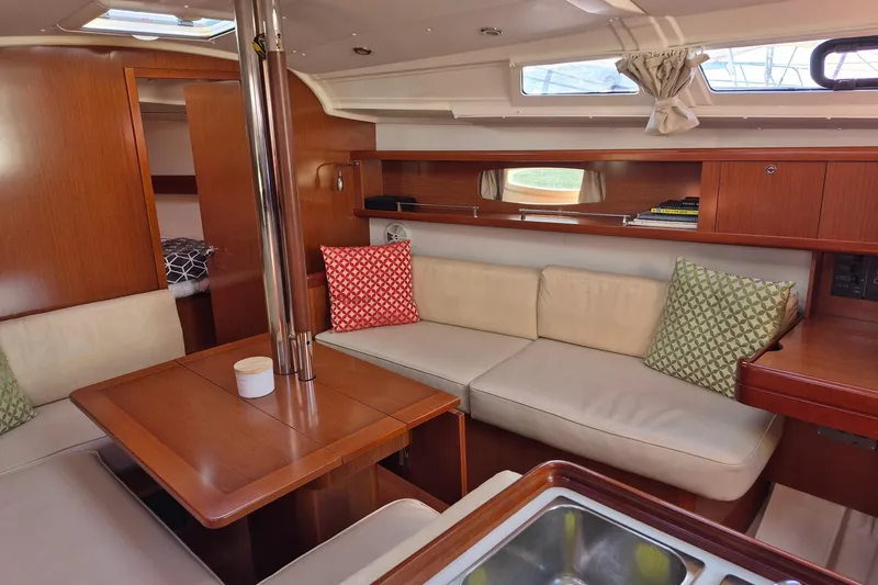 Serene Yacht Photos Pics Interior of 2011 Beneteau Oceanis 37 yacht with cozy seating and wooden finishes.