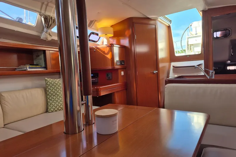 Serene Yacht Photos Pics Interior of 2011 Beneteau Oceanis 37 yacht with wood finish and cozy seating area.