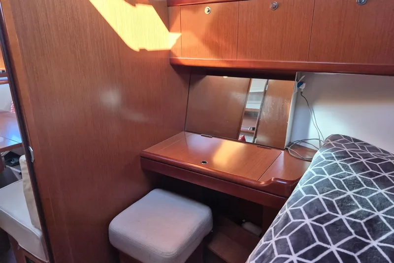 Serene Yacht Photos Pics Cozy interior of 2011 Beneteau Oceanis 37 yacht with wooden desk and mirror.