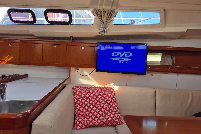 Serene Yacht Photos Pics Interior of 2011 Beneteau Oceanis 37 yacht with TV and cozy seating area.
