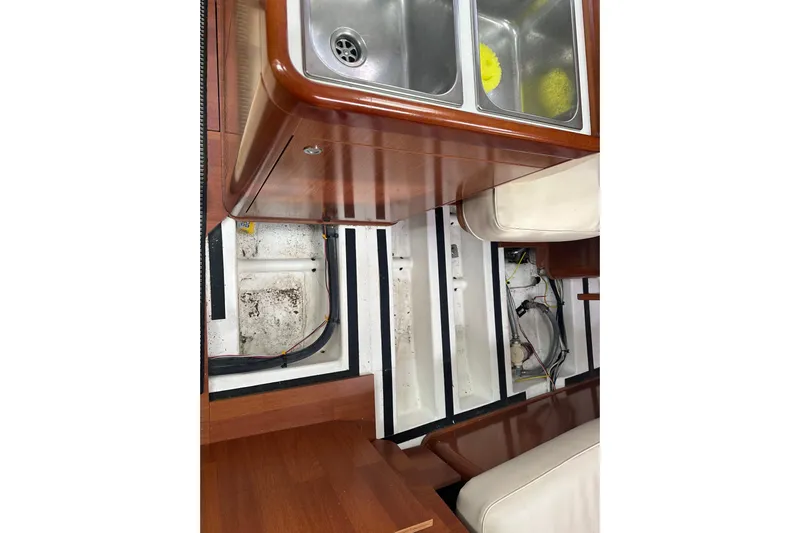 Serene Yacht Photos Pics Interior view of 2011 Beneteau Oceanis 37 yacht, featuring a dual sink and storage compartments.