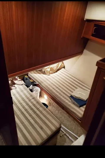 Good Chemistry Yacht Photos Pics 2001 Mainship 430 Trawler cabin with twin beds and wooden interior.