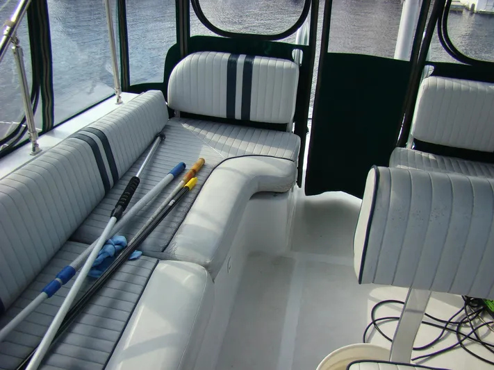 Good Chemistry Yacht Photos Pics 2001 Mainship 430 Trawler interior with striped seating and cleaning tools.