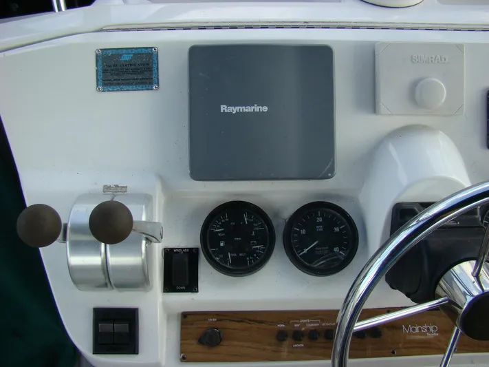 Good Chemistry Yacht Photos Pics 2001 Mainship 430 Trawler helm with Raymarine navigation system and engine controls.