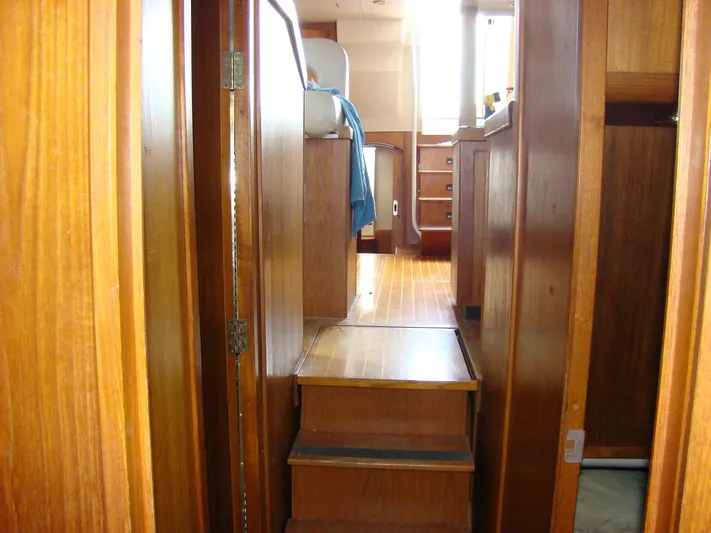 Good Chemistry Yacht Photos Pics Interior of 2001 Mainship 430 Trawler with wooden steps and cabinetry.