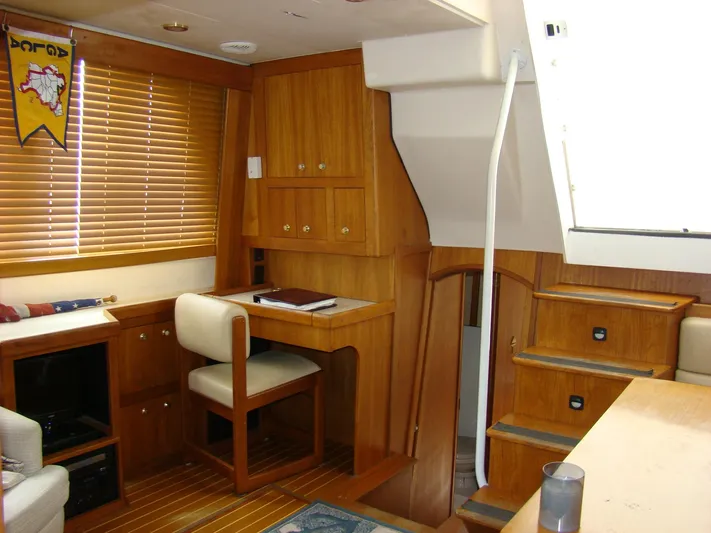 Good Chemistry Yacht Photos Pics 2001 Mainship 430 Trawler interior with wooden cabinetry and stairs.