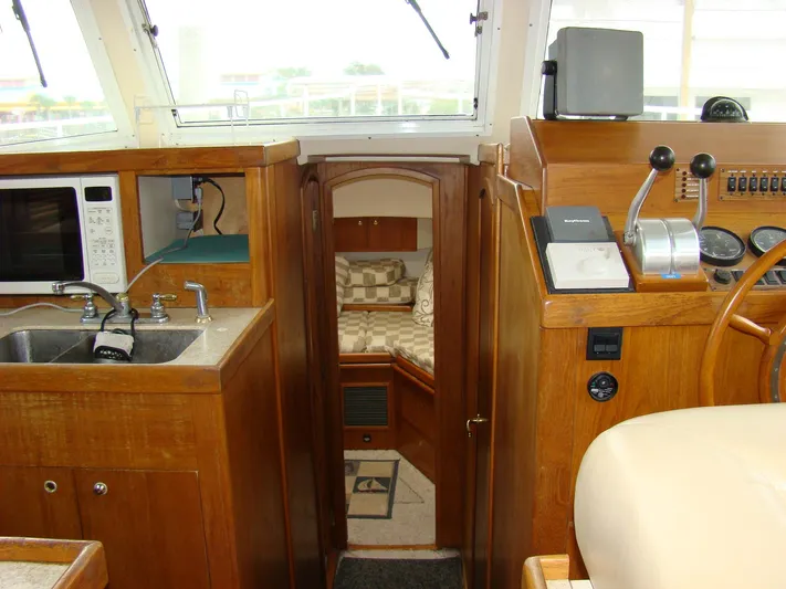 Good Chemistry Yacht Photos Pics Interior of 2001 Mainship 430 Trawler with kitchen, sink, and cozy cabin.