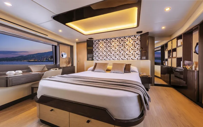 Yacht Photos Pics Luxurious bedroom interior on 2026 Absolute 60 Fly yacht with modern design and scenic window view.