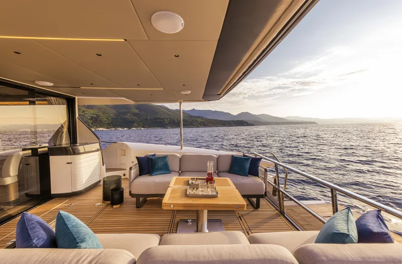 Yacht Photos Pics Luxurious 2026 Absolute 60 Fly yacht deck with ocean view and elegant seating area.