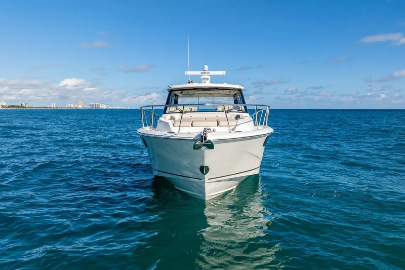 True Companion Yacht Photos Pics 2024 Boston Whaler 405 Conquest boat on open ocean under clear blue sky.