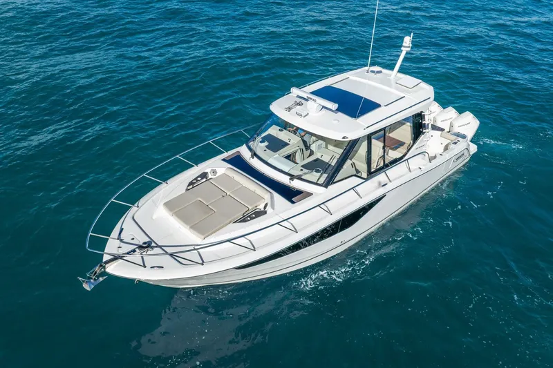 True Companion Yacht Photos Pics 2024 Boston Whaler 405 Conquest cruising on open water, showcasing sleek design and luxury features.