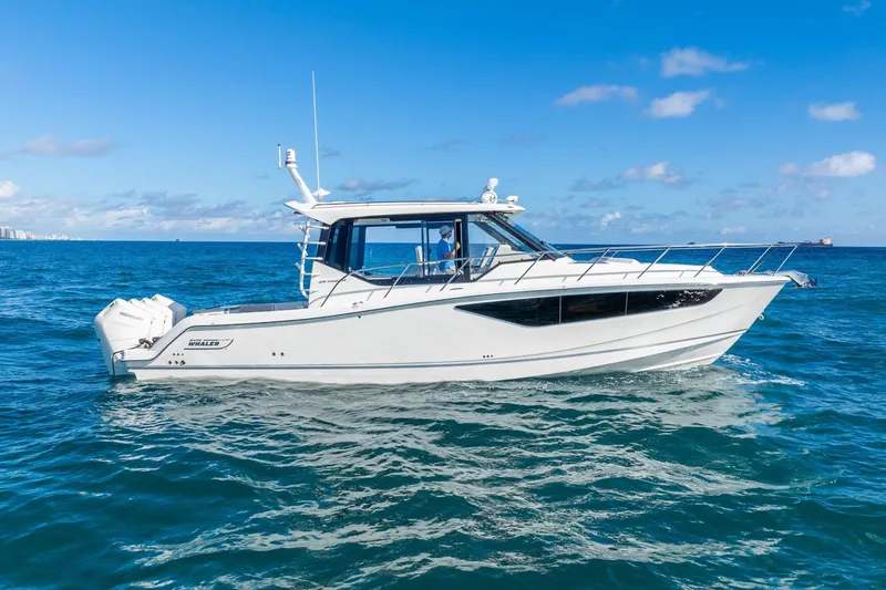 True Companion Yacht Photos Pics 2024 Boston Whaler 405 Conquest boat cruising on open blue ocean.