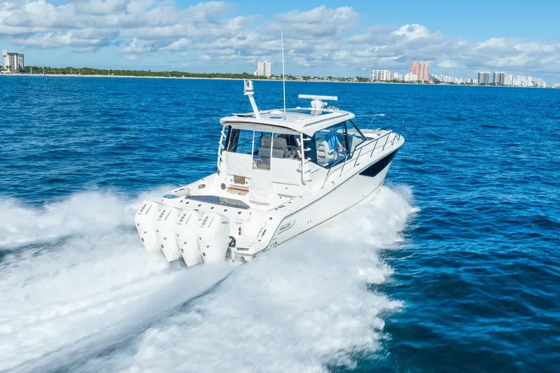 True Companion Yacht Photos Pics 2024 Boston Whaler 405 Conquest cruising on open blue ocean waters.