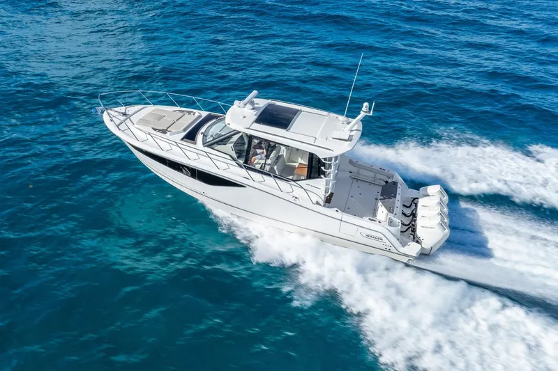 True Companion Yacht Photos Pics 2024 Boston Whaler 405 Conquest cruising on open blue water.