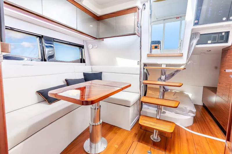 True Companion Yacht Photos Pics Luxurious interior of 2024 Boston Whaler 405 Conquest with elegant seating and wooden accents.