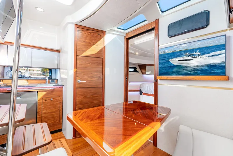 True Companion Yacht Photos Pics Luxurious interior of 2024 Boston Whaler 405 Conquest yacht with wood finishes and modern amenities.