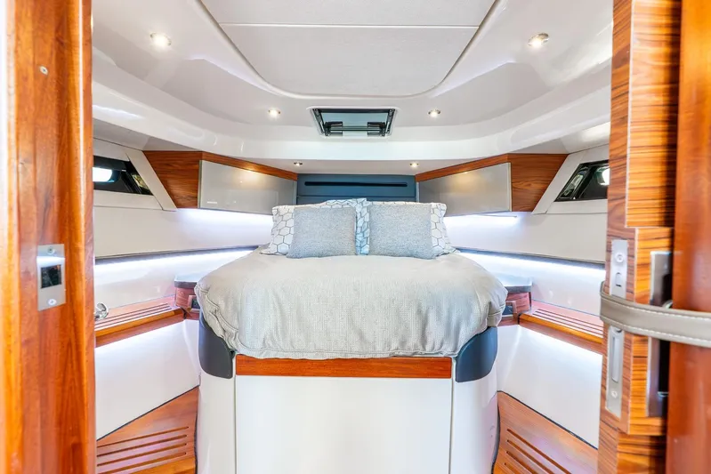 True Companion Yacht Photos Pics Luxurious cabin interior of 2024 Boston Whaler 405 Conquest yacht with elegant bedding.