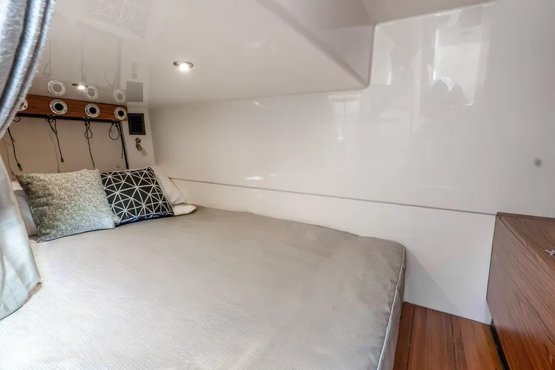 True Companion Yacht Photos Pics Luxurious cabin interior of 2024 Boston Whaler 405 Conquest with cozy bedding and modern design.