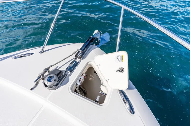 True Companion Yacht Photos Pics 2024 Boston Whaler 405 Conquest bow with anchor and open hatch on blue water.