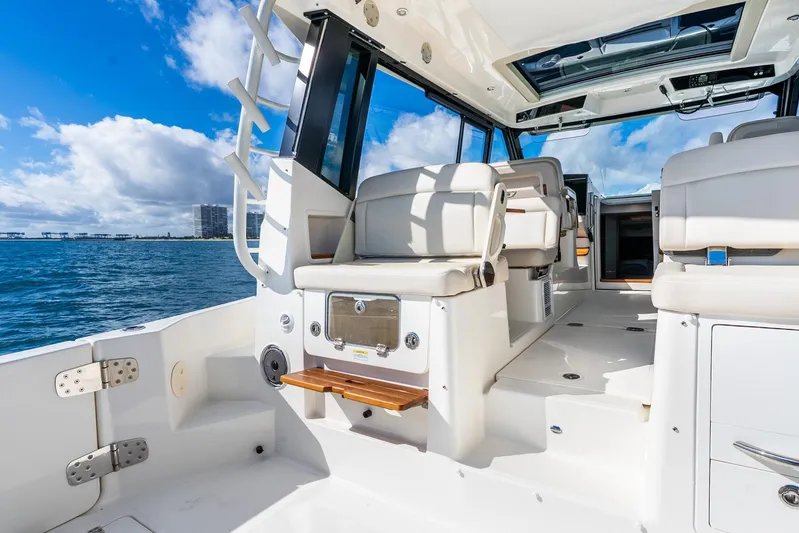 True Companion Yacht Photos Pics 2024 Boston Whaler 405 Conquest boat interior with luxurious seating and ocean view.
