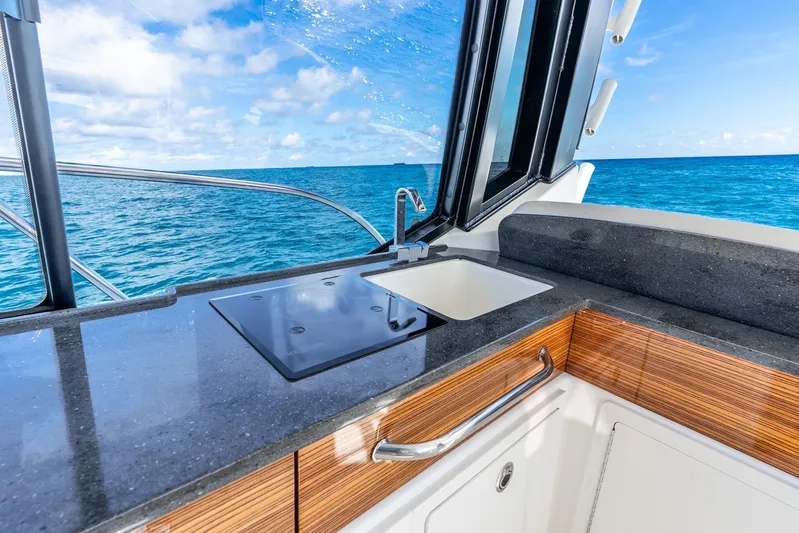 True Companion Yacht Photos Pics Luxurious 2024 Boston Whaler 405 Conquest yacht kitchen with ocean view.