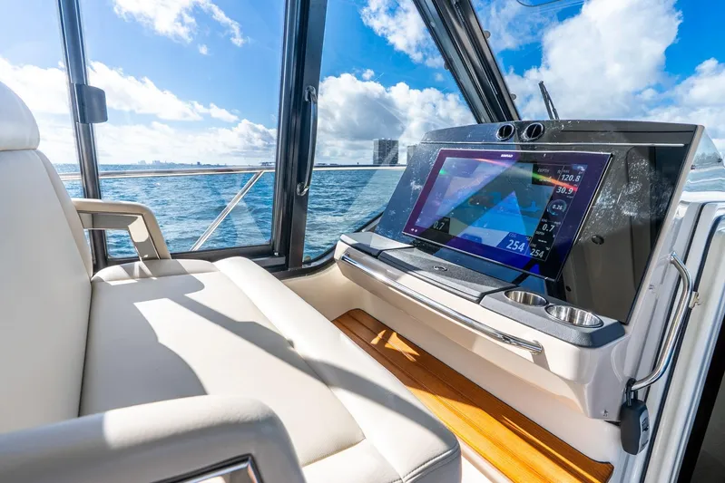 True Companion Yacht Photos Pics 2024 Boston Whaler 405 Conquest interior with modern navigation display and comfortable seating.