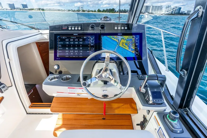 True Companion Yacht Photos Pics 2024 Boston Whaler 405 Conquest helm with advanced navigation displays and controls.
