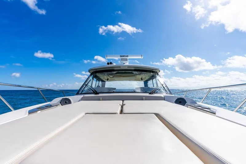 True Companion Yacht Photos Pics Boston Whaler 405 Conquest 2024 on open sea under blue sky.