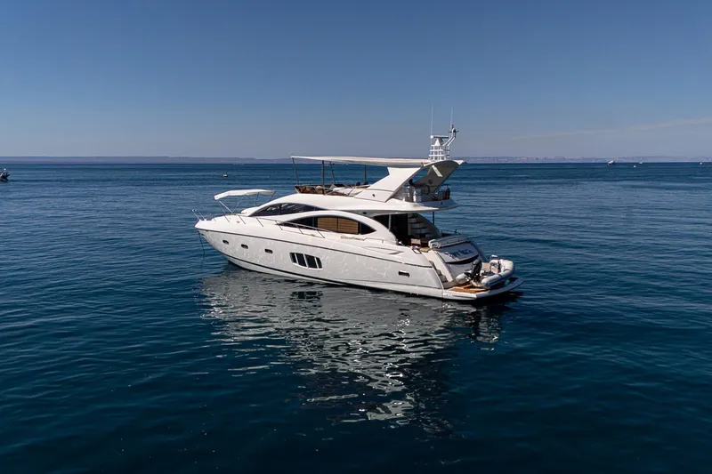 Bar&co Yacht Photos Pics Luxurious 2008 Sunseeker Manhattan 73 yacht cruising on calm blue waters.