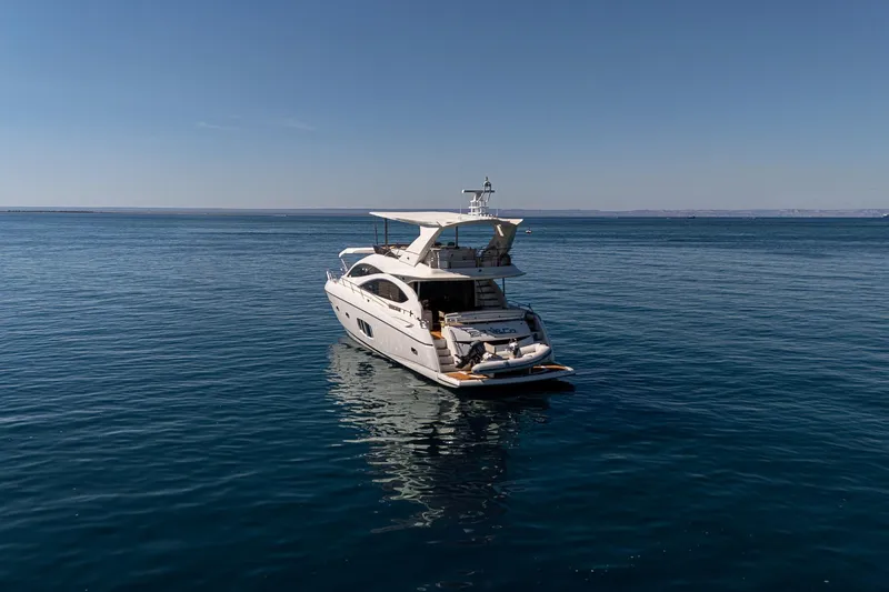 Bar&co Yacht Photos Pics 2008 Sunseeker Manhattan 73 yacht on calm blue sea under clear sky.