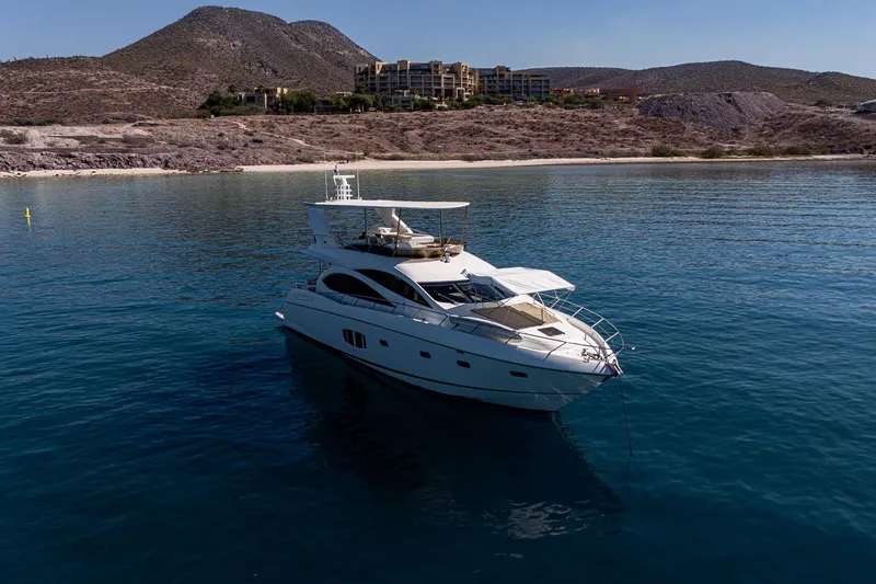 Bar&co Yacht Photos Pics Luxurious 2008 Sunseeker Manhattan 73 yacht anchored in serene coastal waters.
