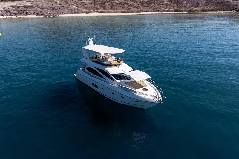 Bar&co Yacht Photos Pics Luxurious 2008 Sunseeker Manhattan 73 yacht anchored in serene blue waters.