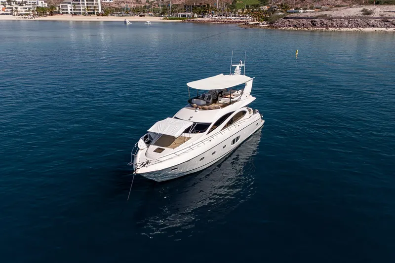 Bar&co Yacht Photos Pics Luxurious 2008 Sunseeker Manhattan 73 yacht cruising in serene blue waters.