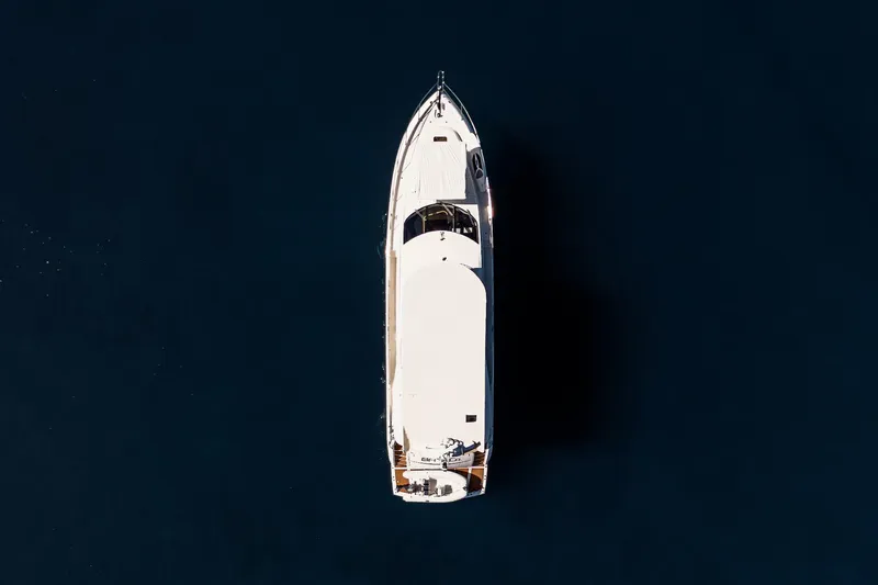 Bar&co Yacht Photos Pics Aerial view of 2008 Sunseeker Manhattan 73 yacht on dark water.