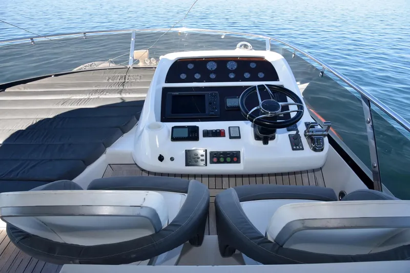 Bar&co Yacht Photos Pics Cockpit of 2008 Sunseeker Manhattan 73 yacht with steering wheel and control panel.