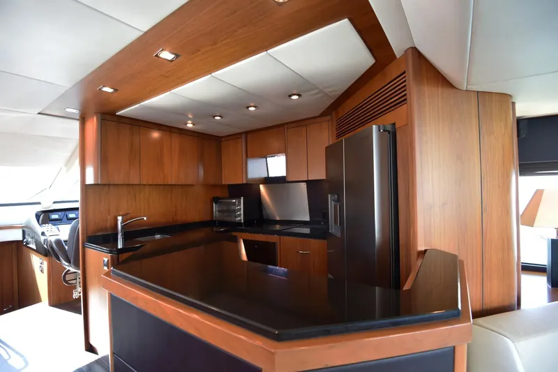Bar&co Yacht Photos Pics Luxurious kitchen interior of 2008 Sunseeker Manhattan 73 yacht with modern wood cabinetry.