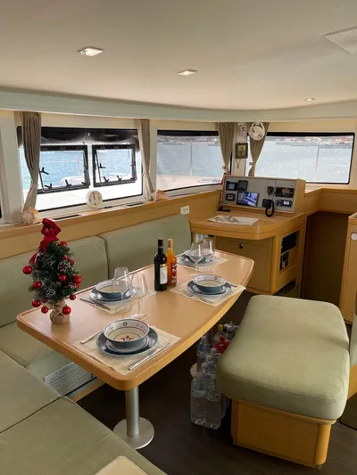 Evolution Yacht Photos Pics Interior of 2017 Lagoon 42 yacht with dining table, festive decor, and scenic window views.