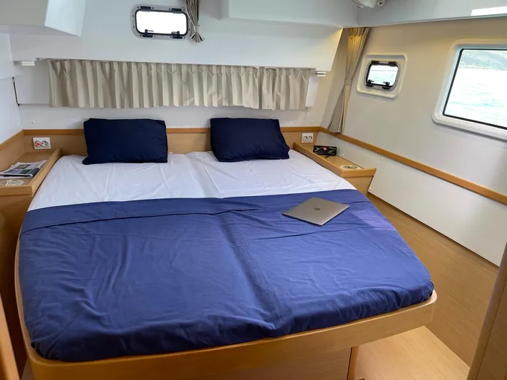 Evolution Yacht Photos Pics Luxurious cabin interior of 2017 Lagoon 42 catamaran with comfortable bed and modern decor.