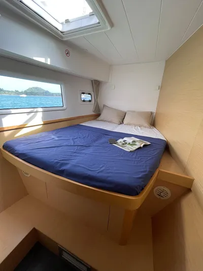 Evolution Yacht Photos Pics Interior cabin of 2017 Lagoon 42 catamaran with bed and window view.