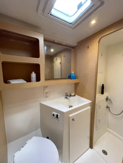 Evolution Yacht Photos Pics Modern bathroom in a 2017 Lagoon 42 yacht with shower, sink, and skylight.