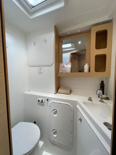 Evolution Yacht Photos Pics Bathroom interior of a 2017 Lagoon 42 yacht, featuring modern fixtures and storage.