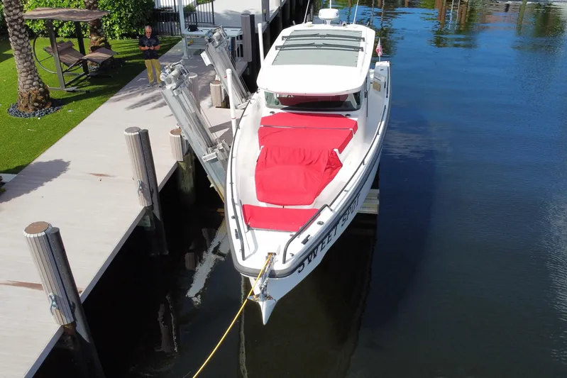 Sweet Spot Yacht Photos Pics 2021 Axopar 37 Cross Cabin boat docked with red cushions, aerial view.