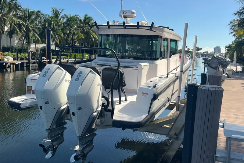 Sweet Spot Yacht Photos Pics 2021 Axopar 37 Cross Cabin boat with dual Mercury engines docked by palm trees.
