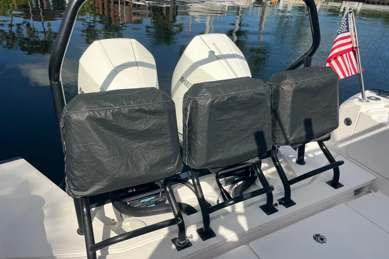 Sweet Spot Yacht Photos Pics 2021 Axopar 37 Cross Cabin boat with covered seats and American flag.