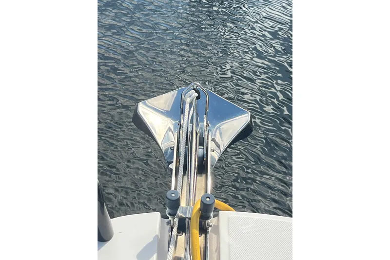 Sweet Spot Yacht Photos Pics Bow of 2021 Axopar 37 Cross Cabin boat with anchor over water.