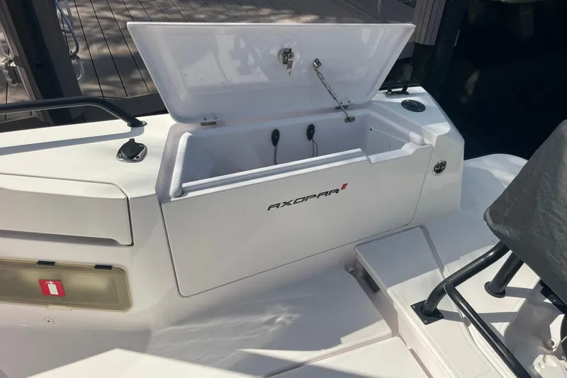 Sweet Spot Yacht Photos Pics 2021 Axopar 37 Cross Cabin storage compartment with open lid on deck.