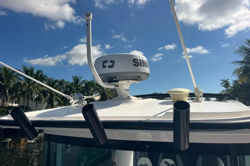 Sweet Spot Yacht Photos Pics 2021 Axopar 37 Cross Cabin boat with radar and antennas under blue sky.