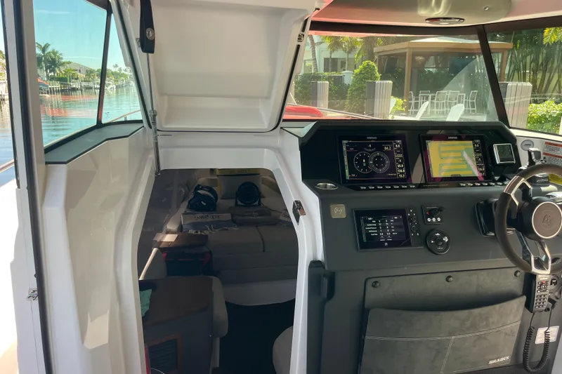 Sweet Spot Yacht Photos Pics 2021 Axopar 37 Cross Cabin interior with navigation displays and steering wheel.