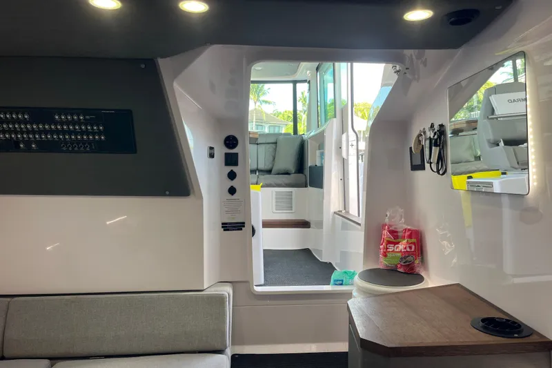 Sweet Spot Yacht Photos Pics Interior of 2021 Axopar 37 Cross Cabin boat, featuring modern seating and control panel.